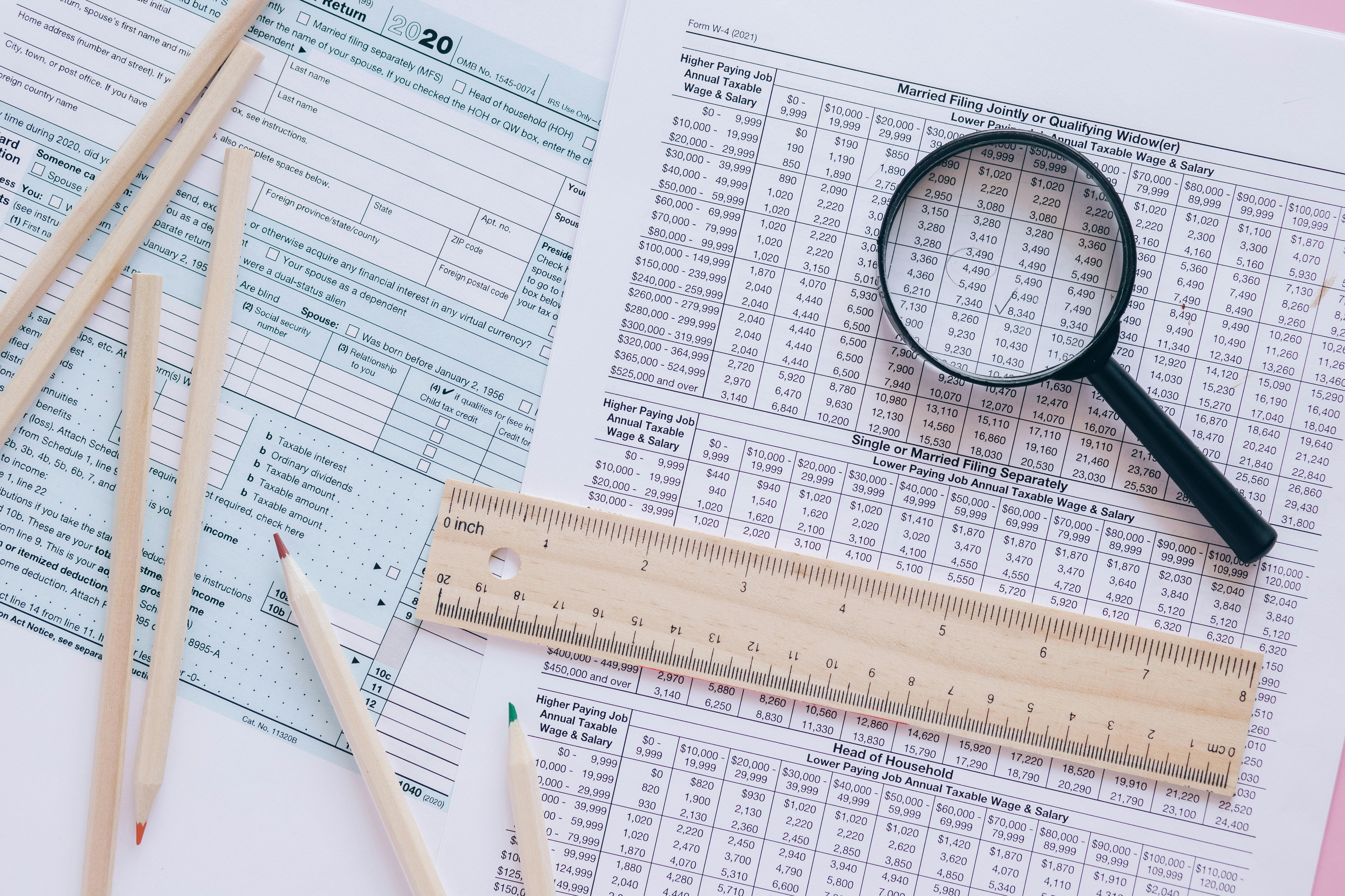 Tax forms and data analysis representing detailed research methodology